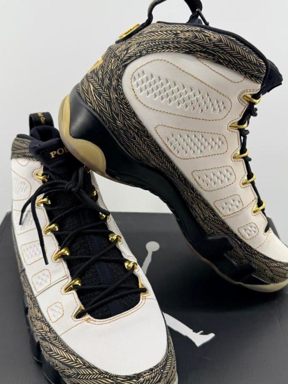 Jordan 9 Retro Pollito sneakers in white with black and gold herringbone pattern